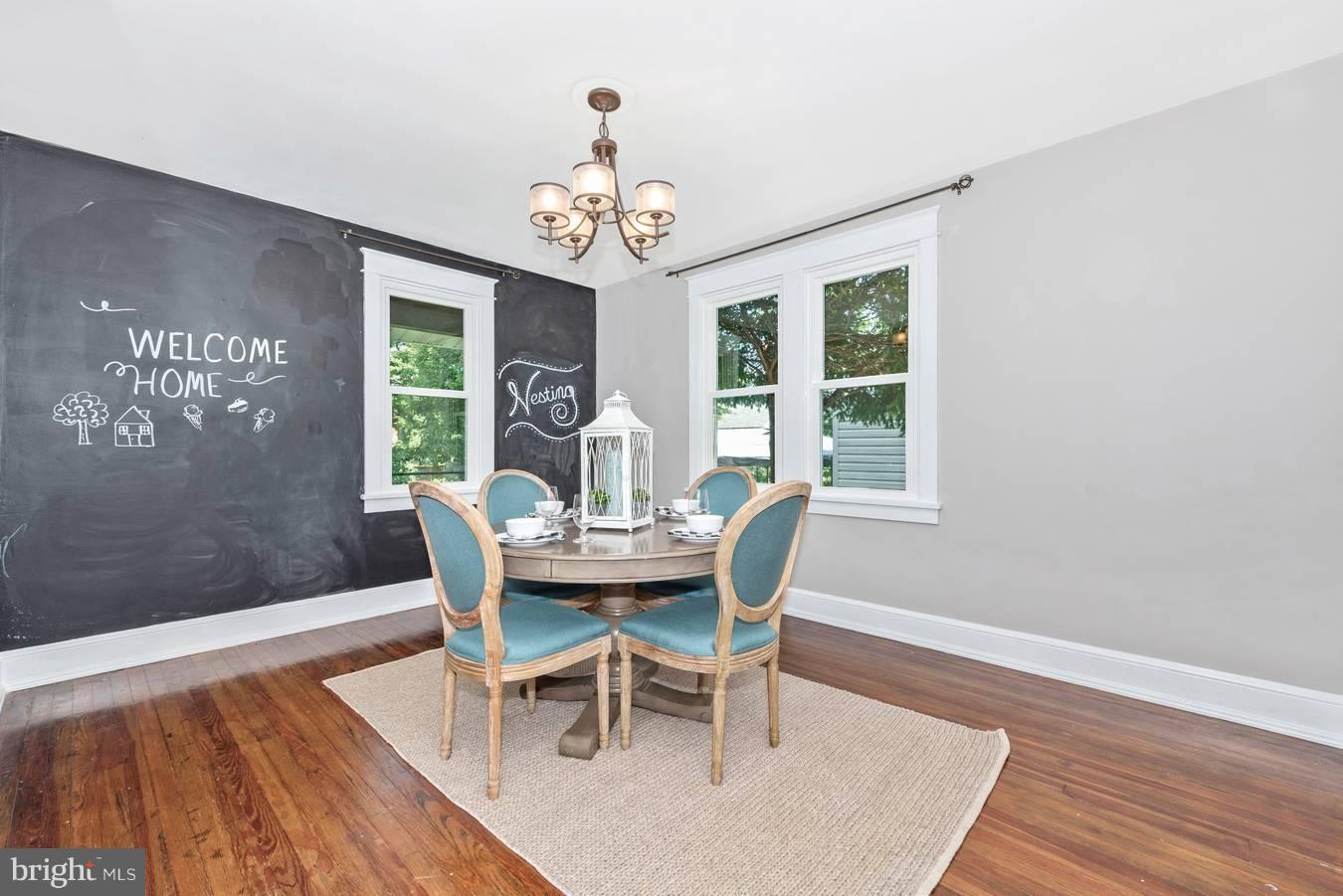 317 Avon Road Hagerstown, MD 21740 - Photo 11 of 30 a view of a dining room with furniture a chandelier and wooden floor