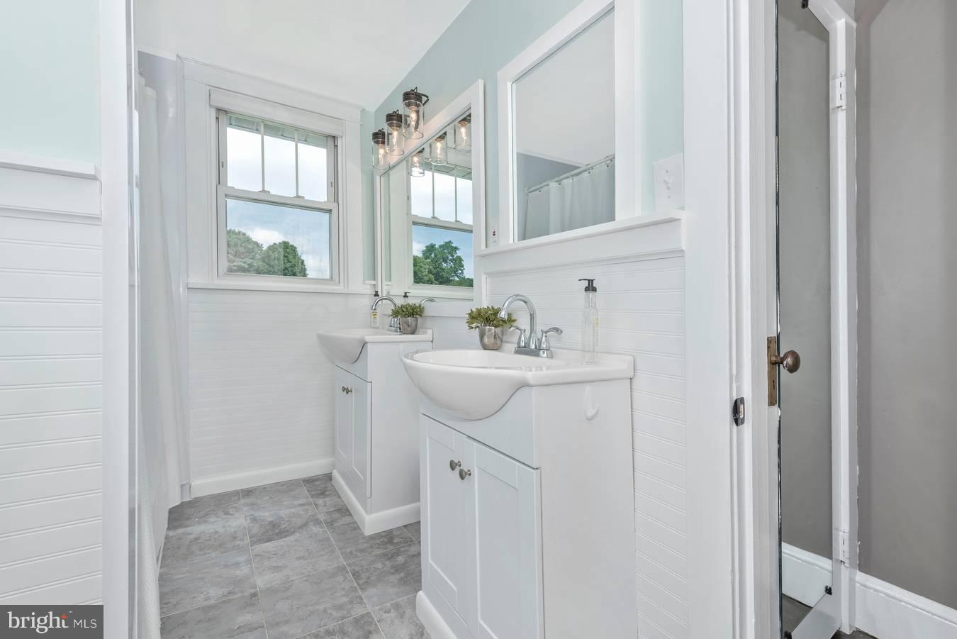 317 Avon Road Hagerstown, MD 21740 - Photo 24 of 30 a bathroom with a sink a window and a mirror