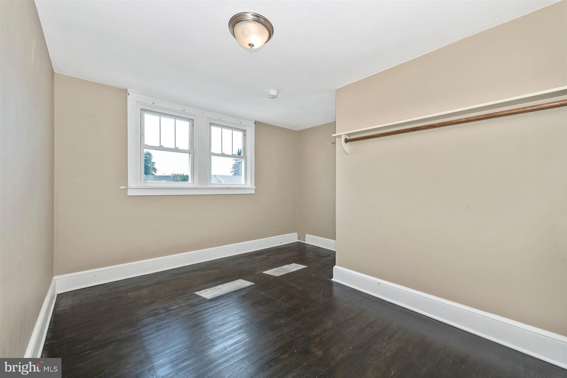 317 Avon Road Hagerstown, MD 21740 - Photo 27 of 30 an empty room with wooden floor and windows