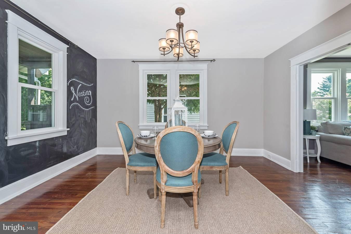 317 Avon Road Hagerstown, MD 21740 - Photo 10 of 30 a dining room with wooden floor a chandelier a wooden table and chairs