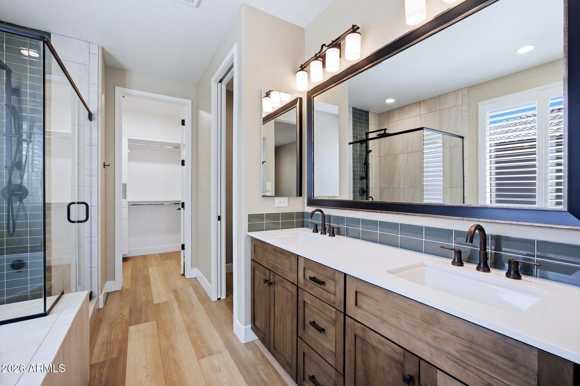 16849 West Merrell Street Goodyear, AZ 85395 - Photo 19 of 35 a spacious bathroom with a double vanity sink a mirror and a shower