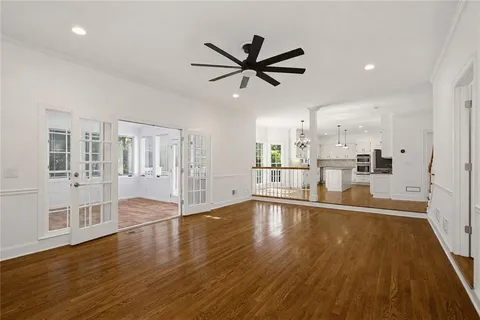 a view of empty room with wooden floor and window