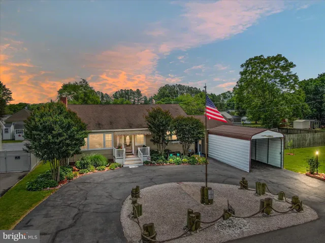 a view of a patio with a dining table and chairs with wooden floor