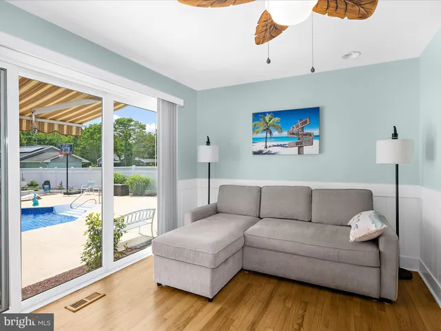 a bedroom with a bed and a flat tv screen on dresser