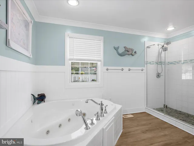 a spacious bathroom with a double vanity sink a mirror and a