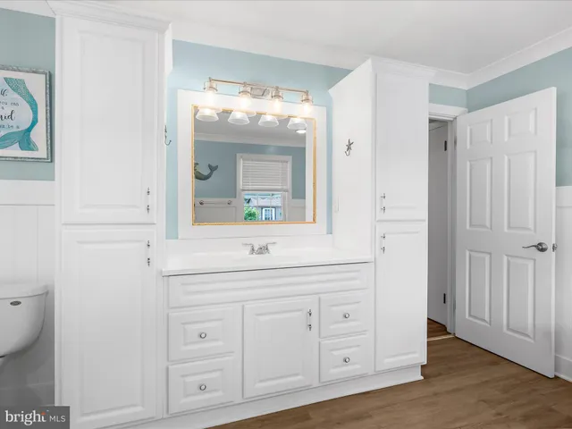 a bedroom with bed and wooden floor