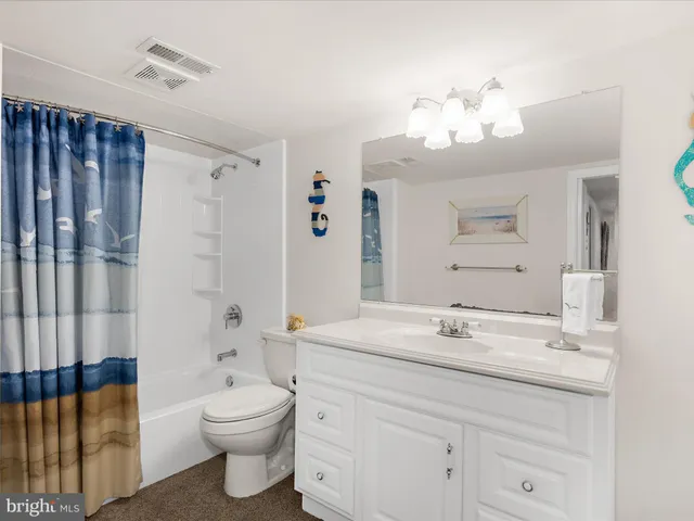 a view of a workspace with furniture and a lamp