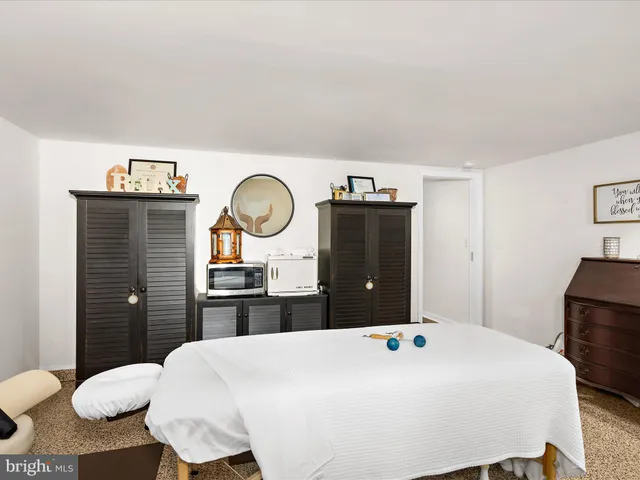 a bedroom with two beds and painting on the wall