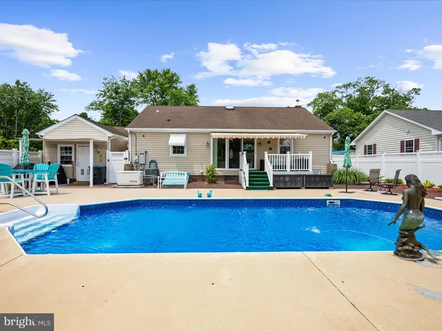 a view of a backyard with furniture and a patio