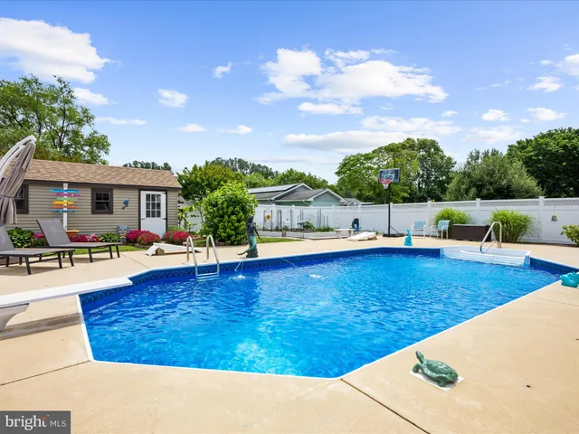 a front view of a house with a yard and fountain