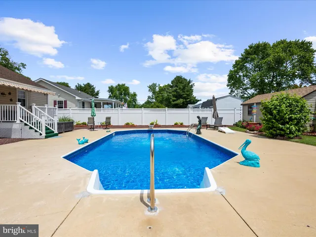 an aerial view of a house with a yard and a large tree