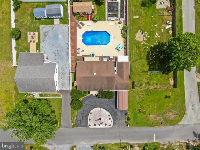 an aerial view of a house with a garden and lake view