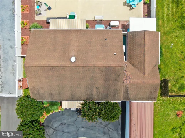 an aerial view of a house with a garden and lake view