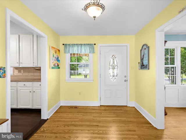 a kitchen with cabinets wooden floor and a sink