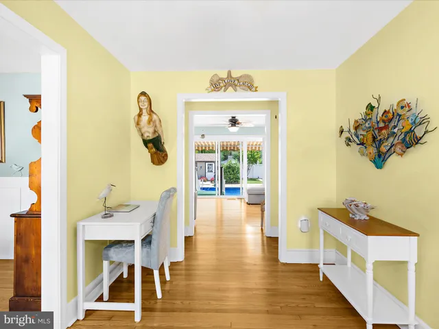 a kitchen with cabinets stainless steel appliances and wooden floor