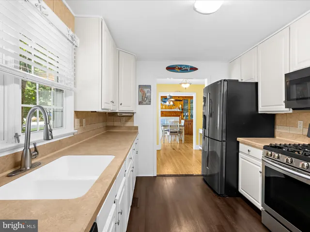 a view of a dining room with furniture a chandelier and wooden floor