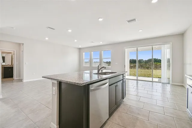 a kitchen with stainless steel appliances granite countertop a stove sink and cabinets