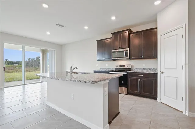 a view of kitchen and refrigerator