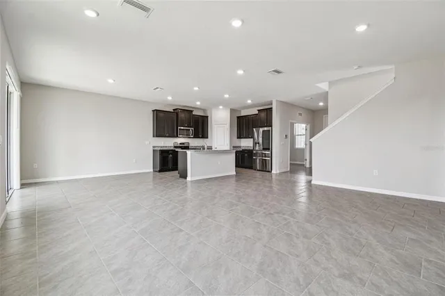 a bathroom with a granite countertop toilet a sink and a mirror
