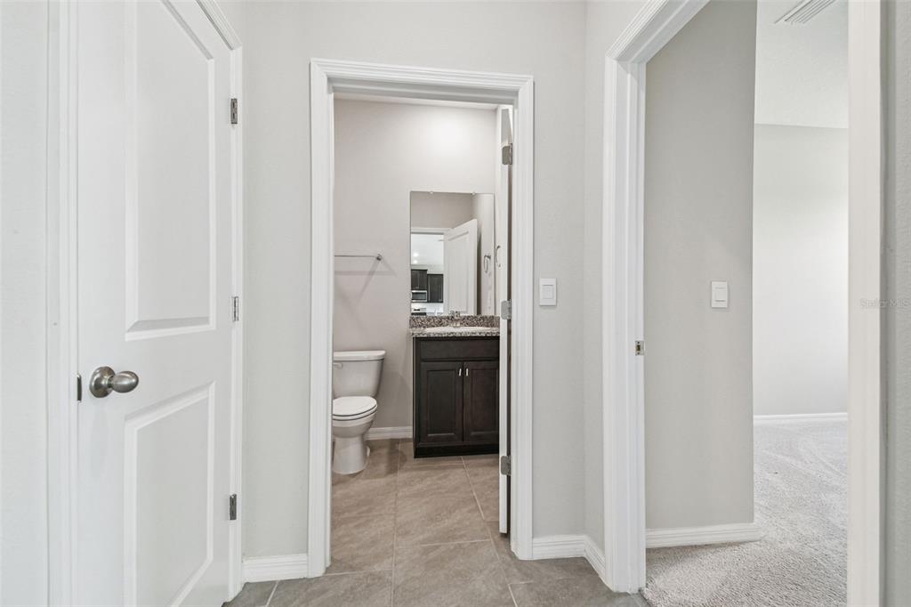 3827 Sunny Spring Street Plant City, FL 33565 - Photo 17 of 57 a en suite bathroom with a toilet sink