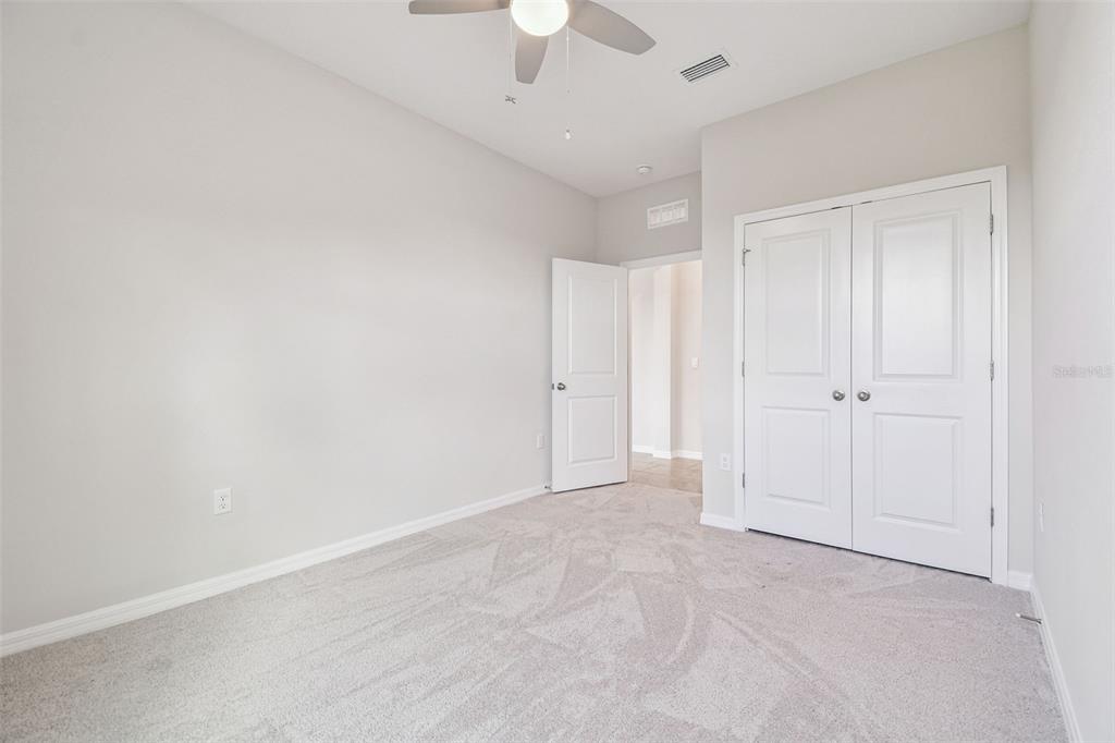 3827 Sunny Spring Street Plant City, FL 33565 - Photo 21 of 57 an empty room with a ceiling fan and a window
