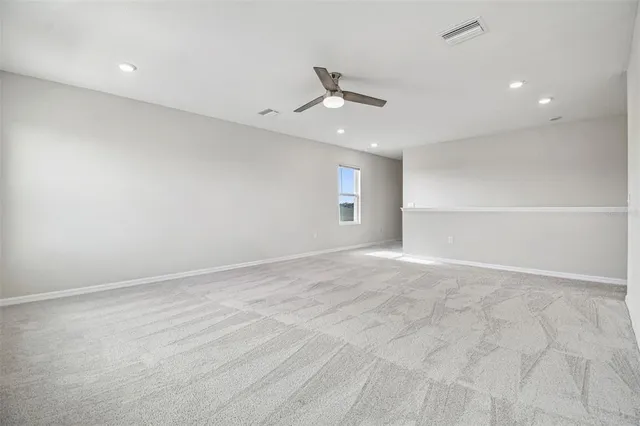 an empty room with a ceiling fan