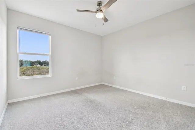 a bathroom with a granite countertop toilet sink and mirror