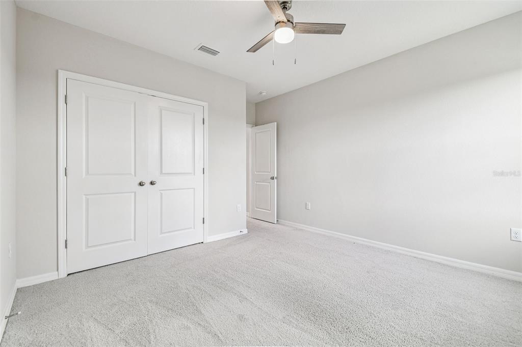 3827 Sunny Spring Street Plant City, FL 33565 - Photo 25 of 57 an empty room with a ceiling fan