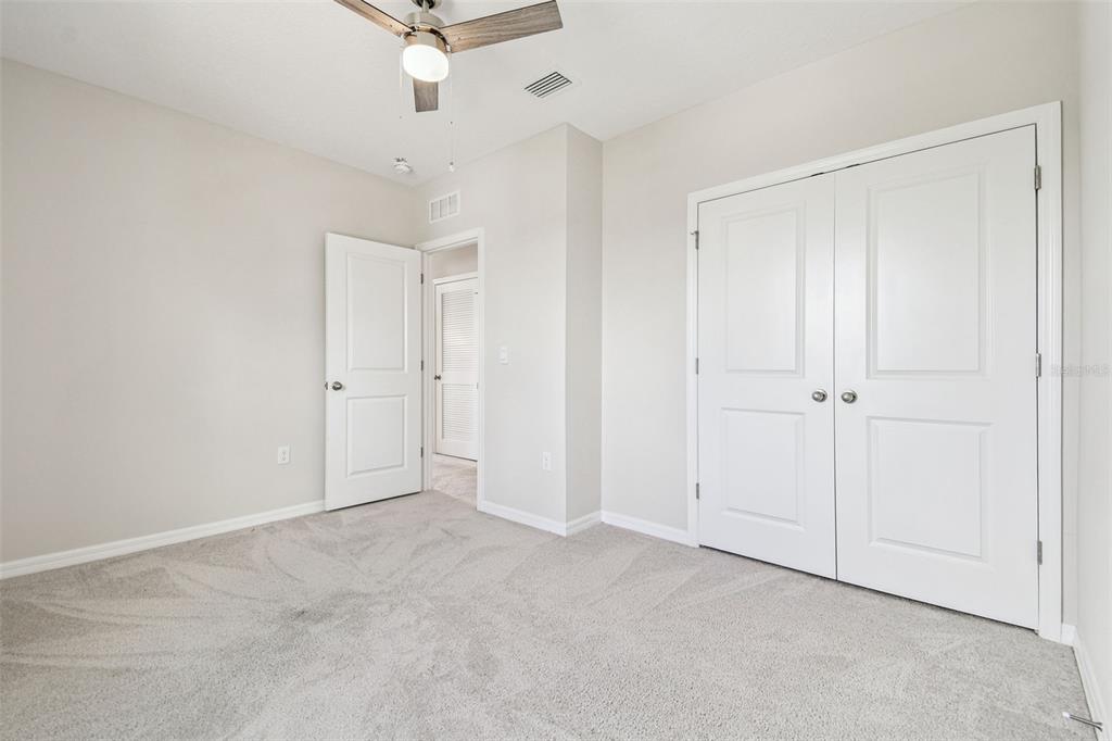 3827 Sunny Spring Street Plant City, FL 33565 - Photo 29 of 57 an empty room with a ceiling fan