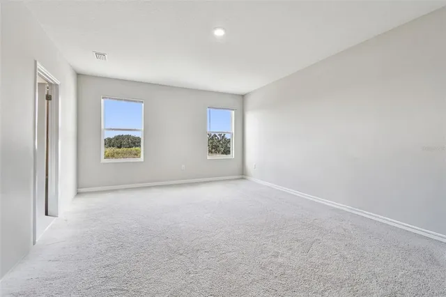 a spacious bathroom with a granite countertop sink mirror and bathtub