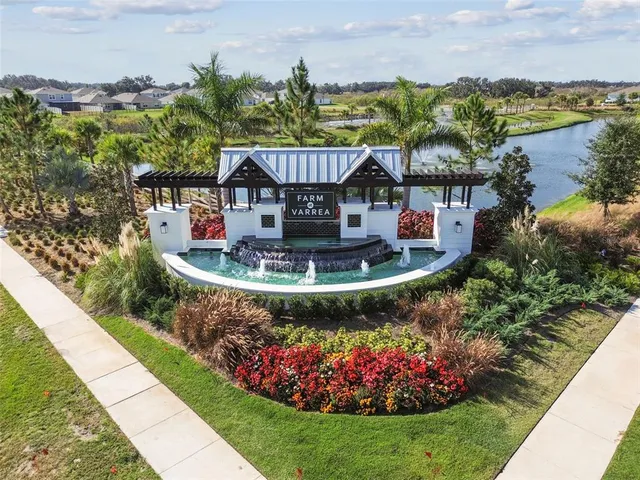 a view of a house with a yard and potted plants