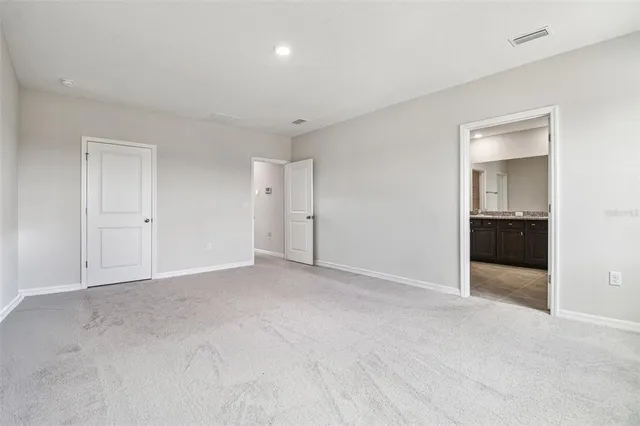 a bathroom with a granite countertop double vanity sink and a mirror