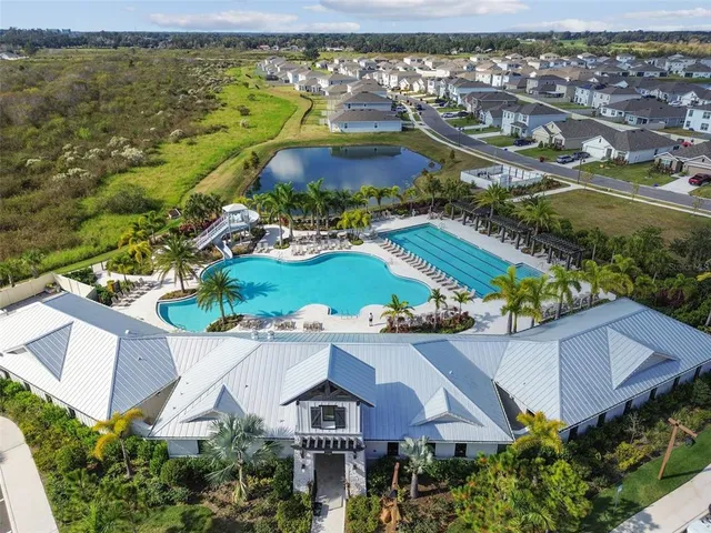 an aerial view of residential houses with outdoor space and river