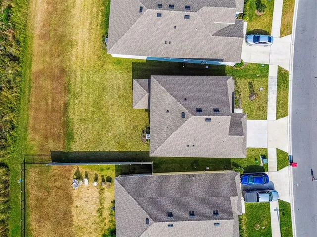 an aerial view of a house with a lake view