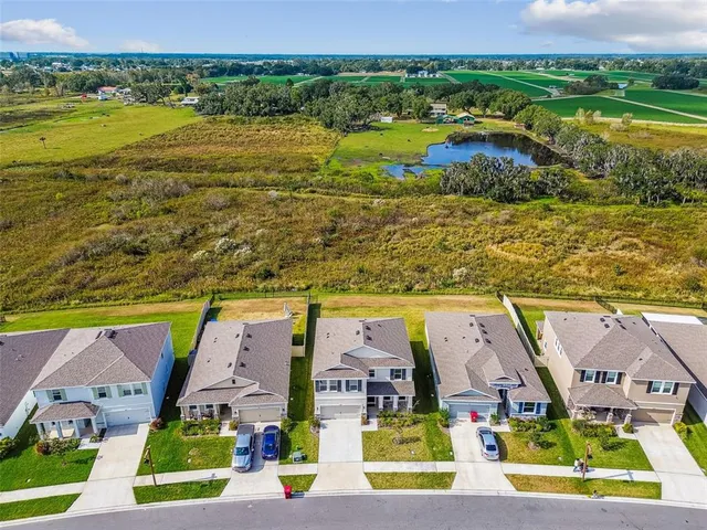 an aerial view of a house with garden space swimming pool