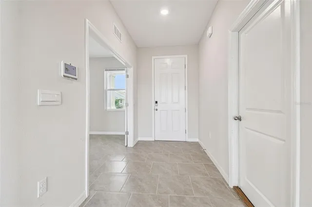 a view of a hallway with wooden shelves