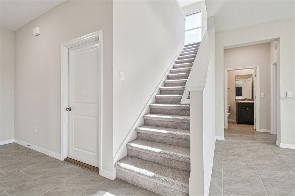3827 Sunny Spring Street Plant City, FL 33565 - Photo 8 of 57 a view of an entryway with wooden floor and stairs