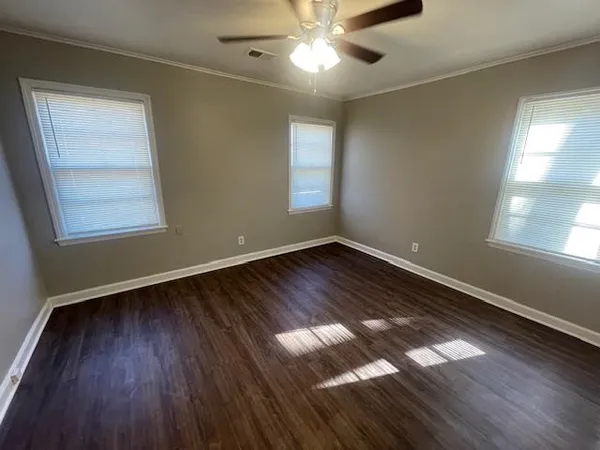 wooden floor in an empty room with a window