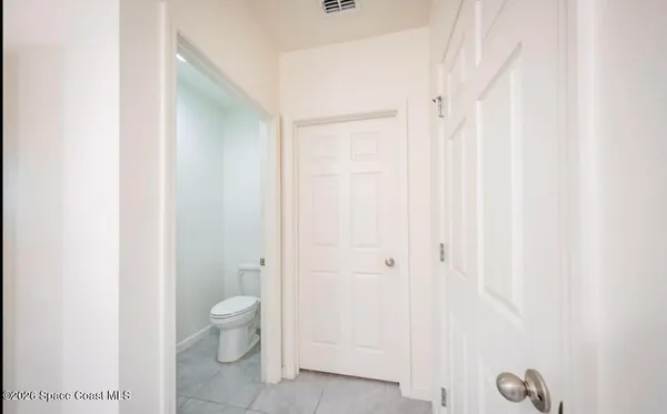a bathroom with a granite countertop sink a toilet and a shower