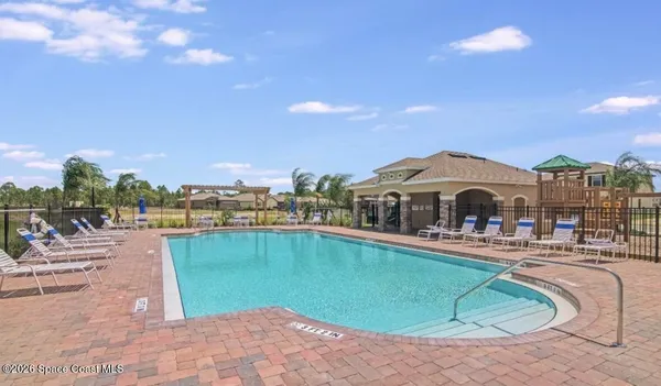 a swimming pool with outdoor seating and yard