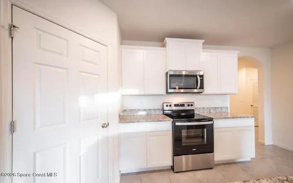 a kitchen with a sink and a stove top oven