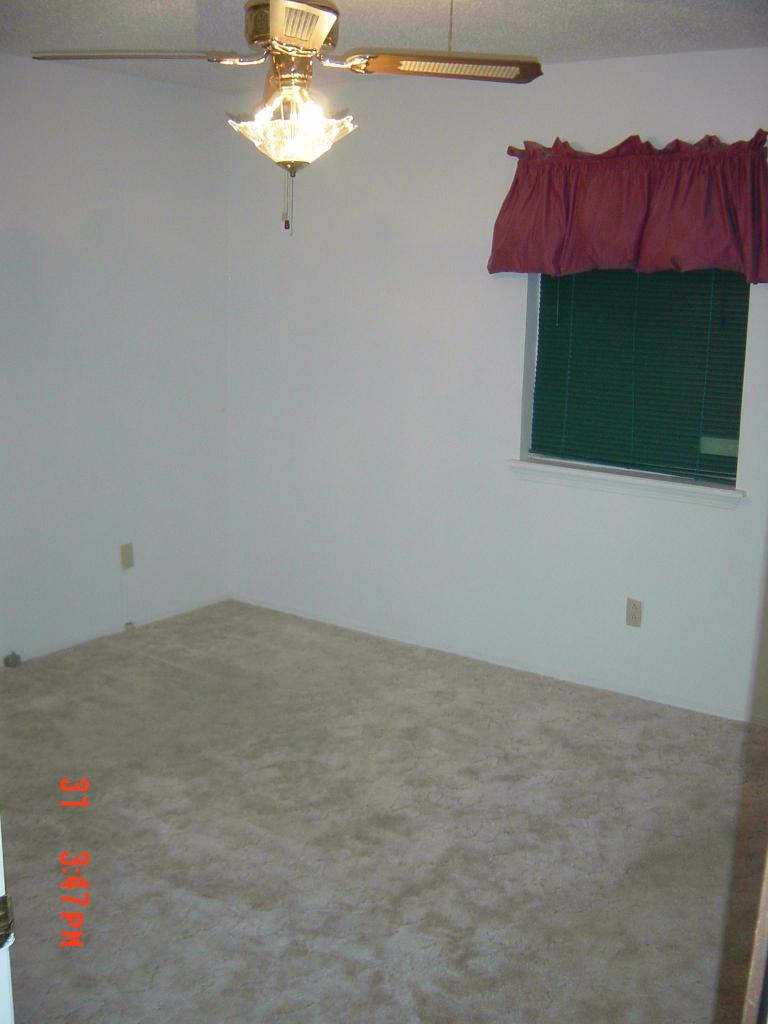 8131 Coronado Trail Amarillo, TX 79110 - Photo 10 of 12 a view of a room with a ceiling fan and a potted plant