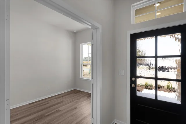 a view of a room with shelves and wooden floor