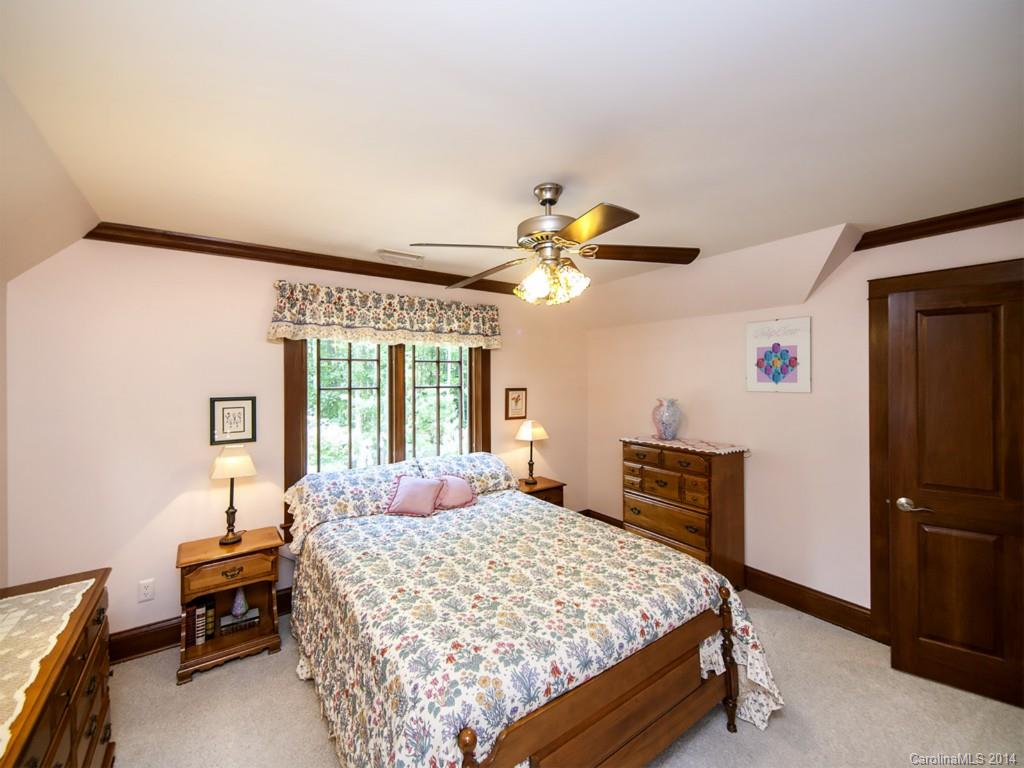 7112 Old Ridge Road Waxhaw, NC 28173 - Photo 14 of 24 a bedroom with a large bed and a chandelier