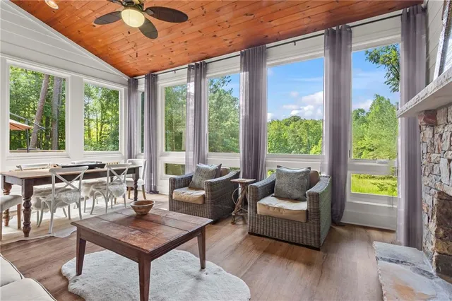 a spacious bathroom with a granite countertop sink a mirror and a shower