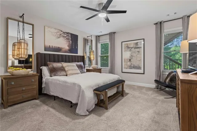 an aerial view of a residential houses with outdoor space and trees all around