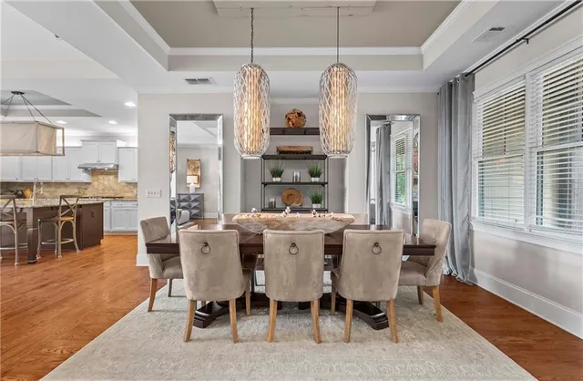 a living room with furniture a chandelier and a large window