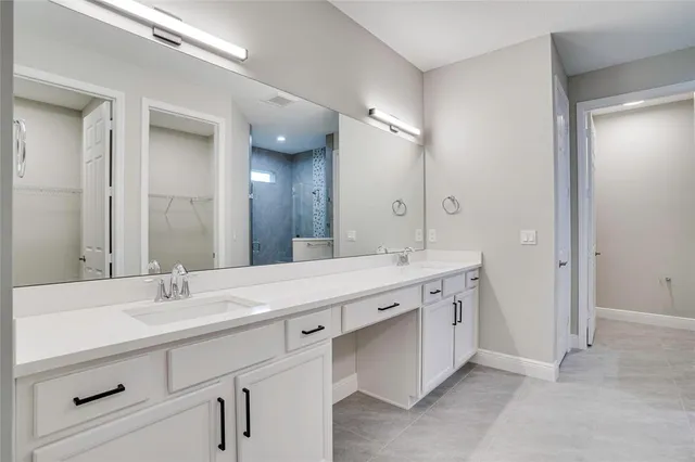 a bathroom with a sink double vanity and a mirror