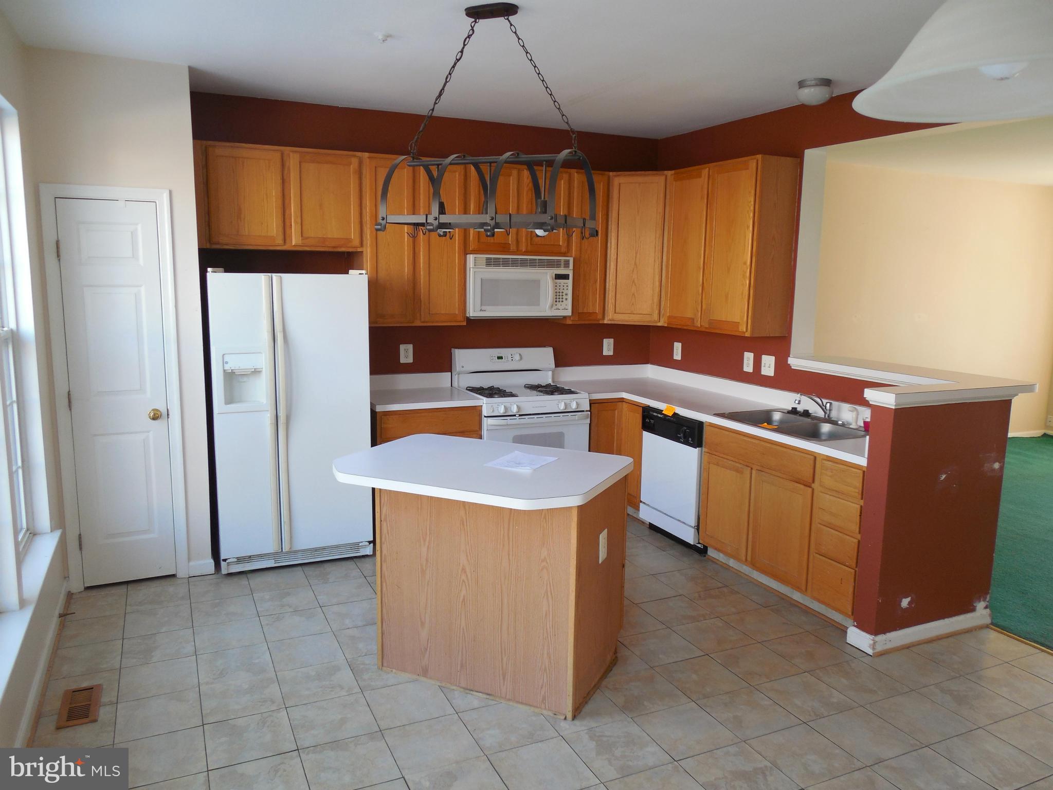 5540 Upshur Square Frederick, MD 21703 - Photo 3 of 8 a kitchen with a stove top oven cabinets and a refrigerator
