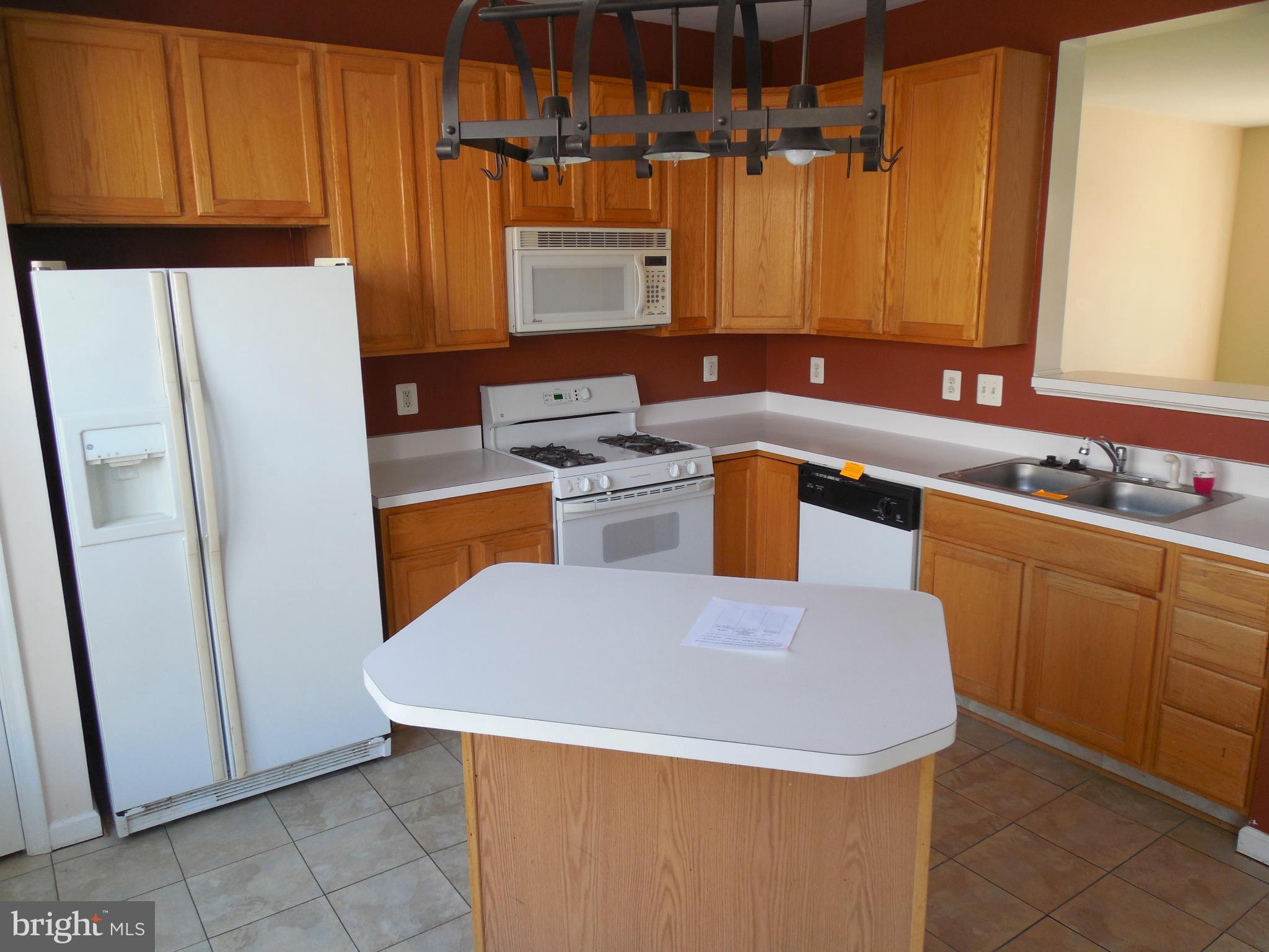 5540 Upshur Square Frederick, MD 21703 - Photo 4 of 8 a kitchen with a sink a stove and refrigerator